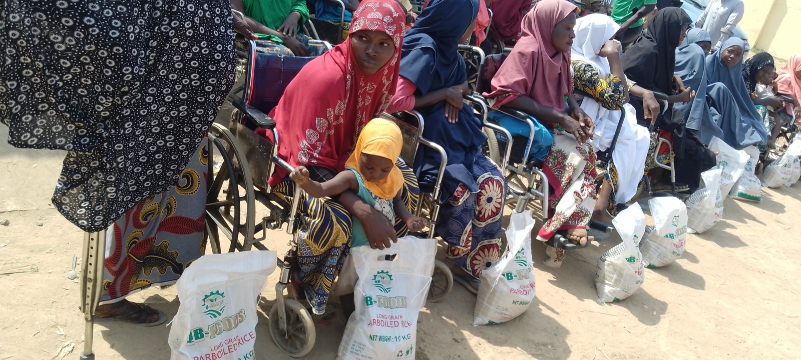 A mother and child receiving support at the Karamajiji Disability Village Christmas outreach